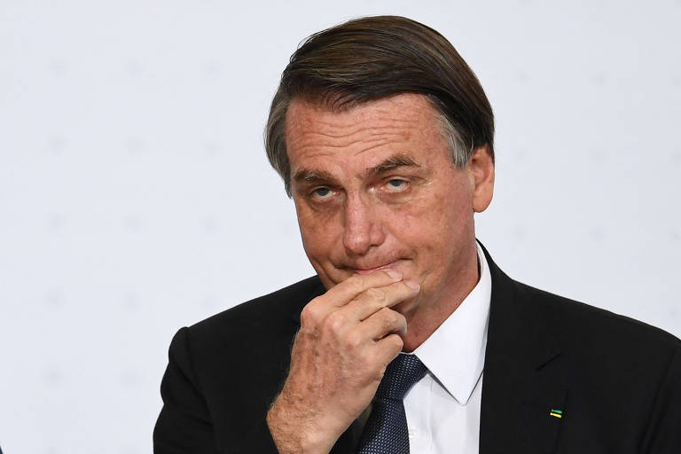 Bolsonaro coloca a mão no queixo com expressão séria