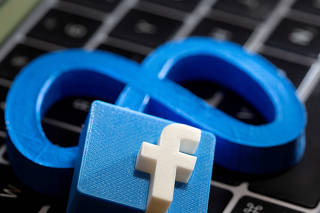 FILE PHOTO: A 3D printed Facebook's new rebrand logo Meta and Facebook logo are placed on laptop keyboard in this illustration