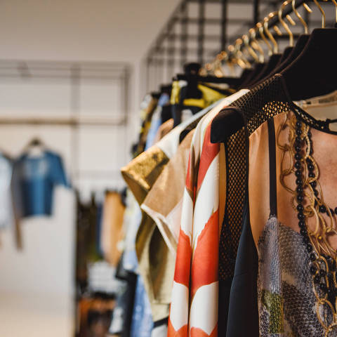 Clothes on hangers in a retail shop