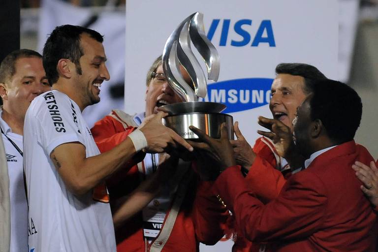 Edu Dracena, então capitão do Santos, recebe a taça da Libertadores das mãos de Pelé, em 2011, no Pacaembu