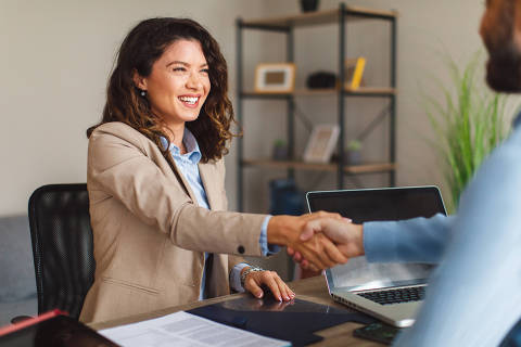 Young woman signing contracts and handshake with a manager. Credit Djile / Adobe Stock