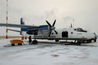 A Polar Airlines' Antonov An-24 passenger aircraft is serviced at an airport in Yakutsk