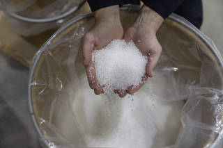 Dustin Olson, chief executive of PureCycle Technologies, holds a handful of pure recycled polypropylene pellets at the company's plant in Ironton, Ohio, March 13, 2024. (Maddie McGarvey/The New York Times)