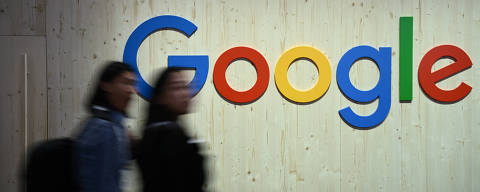 People walk next to a Google logo during a trade fair in Hannover Messe, in Hanover, Germany, April 22, 2024.  REUTERS/Annegret Hilse ORG XMIT: LIVE