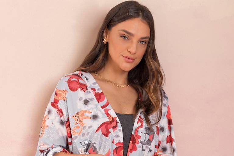 Modelo (mulher) veste pijama estampado da marca Mensageiro dos Sonhos, feito com tecido mais adequado a invernos amenos