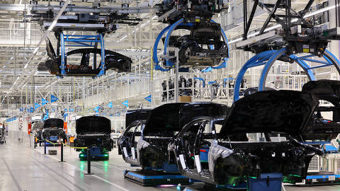 FILE PHOTO: Car bodies are lifted at 