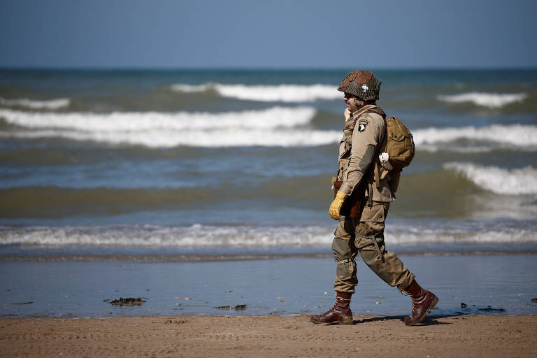 Ator vestido de soldado americano em encenação do Dia D na praia de Utah