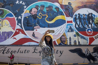 FILE PHOTO: FILE PHOTO: Woman takes selfie in front of Absolute Equality mural in Galveston, Texas