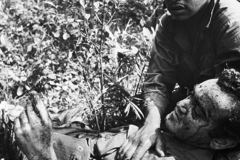 O jornalista José Hamilton Ribeiro é amparado instantes após pisar numa mina e ter parte da perna esquerda destroçada, em 20 de março de 1968, no Vietnã
