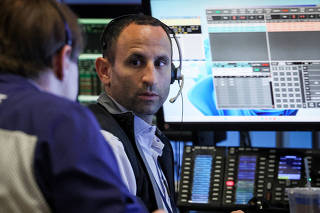 Traders work on the floor of the NYSE in New York