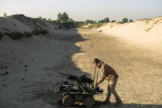 Roboneers, a Ukrainian company, developed an automated weapon with a gun turret mounted on a rolling drone. (Sasha Maslov/The New York Times)