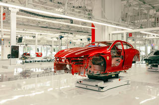 A car on the production line at FerrariÕs new Òe-buildingÓ factory in Maranello, Italy, which is used to make gas and hybrid cars, on June 20, 2024. The facility will also be used to produce the companyÕs first fully electric vehicle. (Maurizio Fiorino/The New York Times)