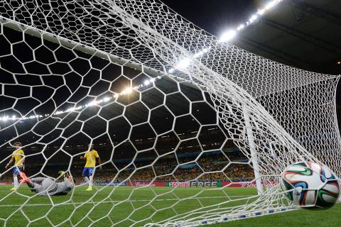 Germany's forward Andre Schuerrle (2nd L) kicks past Brazil's goalkeeper Julio Cesar (4th L, grey) to score his team's sixth goal during the semi-final football match between Brazil and Germany at The Mineirao Stadium in Belo Horizonte during the 2014 FIFA World Cup on July 8, 2014.   AFP PHOTO / PATRIK STOLLARZ ORG XMIT: 2284