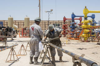 Workers at a Permian Deep Rock site in Midland, Texas, July 3, 2024. (Desiree Rios/The New York Times)
