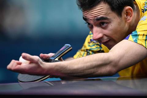 Brazil's Hugo Calderano prepares to serve to South Korea's Jang Woojin during their men's table tennis singles quarter-finals at the Paris 2024 Olympic Games at the South Paris Arena in Paris on August 1, 2024. (Photo by JUNG Yeon-je / AFP)