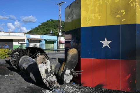 The remains of a statue of late Venezuelan President Hugo Chavez destroyed and burned during a protest against the government of Venezuelan President Nicolas Maduro are pictured in Mariara, Carabobo State, Venezuela, on July 31, 2024. Venezuelan President Nicolas Maduro said Wednesday he was willing to share evidence of his election win, with international pressure mounting for him to back up a disputed victory that has sparked deadly protests. (Photo by YURI CORTEZ / AFP)