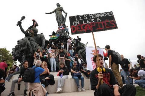 A protester holds a placard reading 