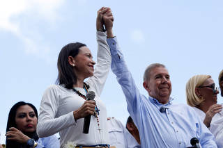 FILE PHOTO: Opposition leader Maria Corina Machado and opposition candidate Edmundo Gonzalez gesture as they address supporters