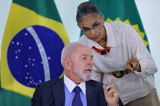 Brazil's President Luiz Inacio Lula da Silva speaks with Brazil's Minister of Environment Marina Silva during a meeting, in Brasilia