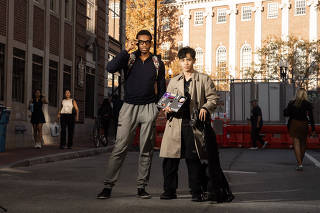 Caine Ardayfio, left, and AnhPhu Nguyen, students at Harvard University who use widely available technology, including Ray-Ban Meta smart glasses, to identify people on the street, in Cambridge, Mass., Oct. 19, 2024. (David Degner/The New York Times)