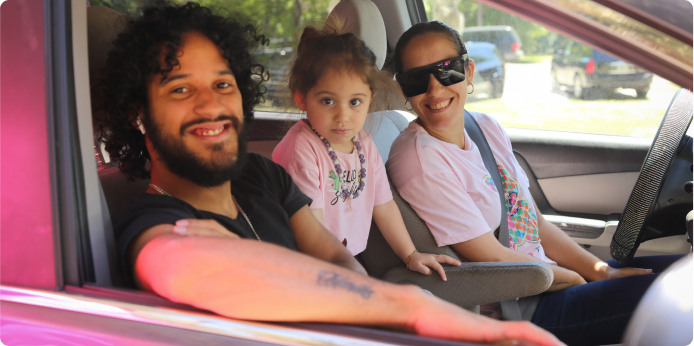 Happy family in car receiving SnackPacks