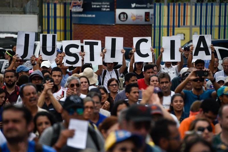 Venezuelan opposition supporters gather to listen to the head of Venezuela's National Assembly and the country's self-proclaimed acting president, Juan Guaidó, during a rally in Caracas on Jan. 26. (FEDERICO PARRA/AFP/Getty Images)