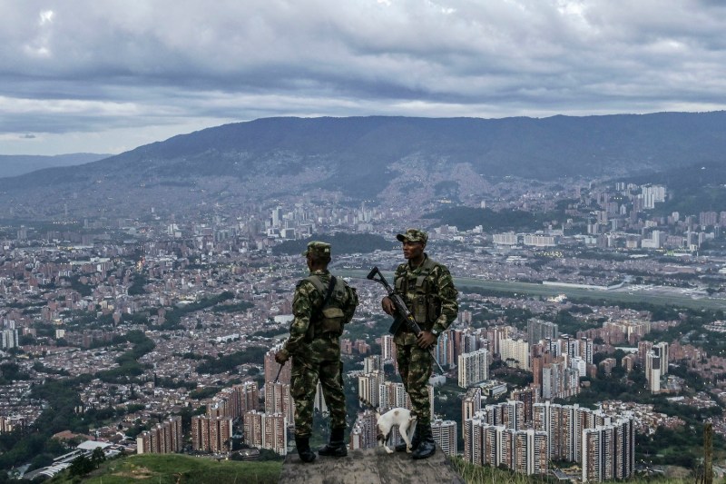 Colombian soldiers stand guard as they patrol the outskirts of Medellin, Antioquia department, on June 6.