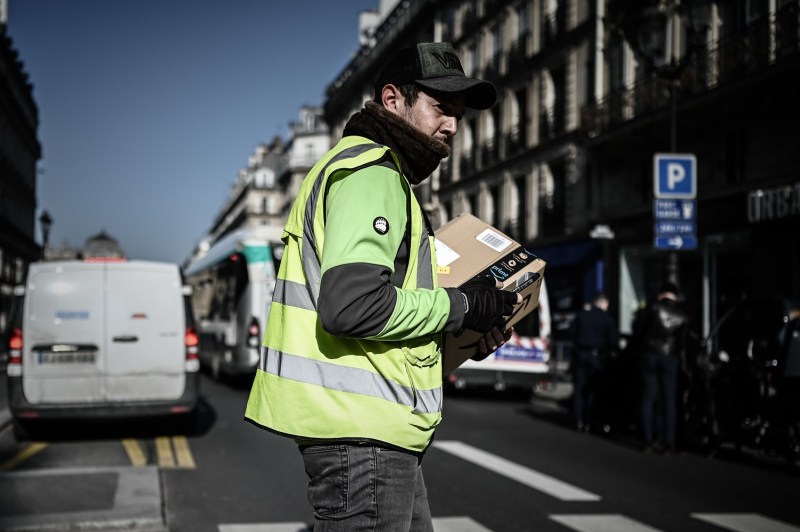 A man delivers an Amazon parcel in Paris