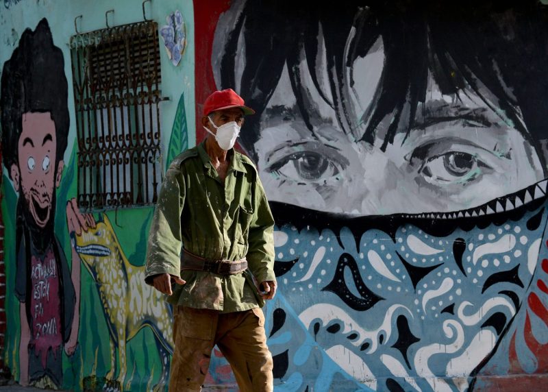 A man wearing a face mask walks along a street of Havana on July 29.