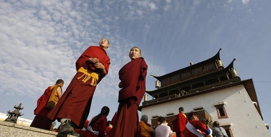 Buddhist monks wait for the Dalai Lama