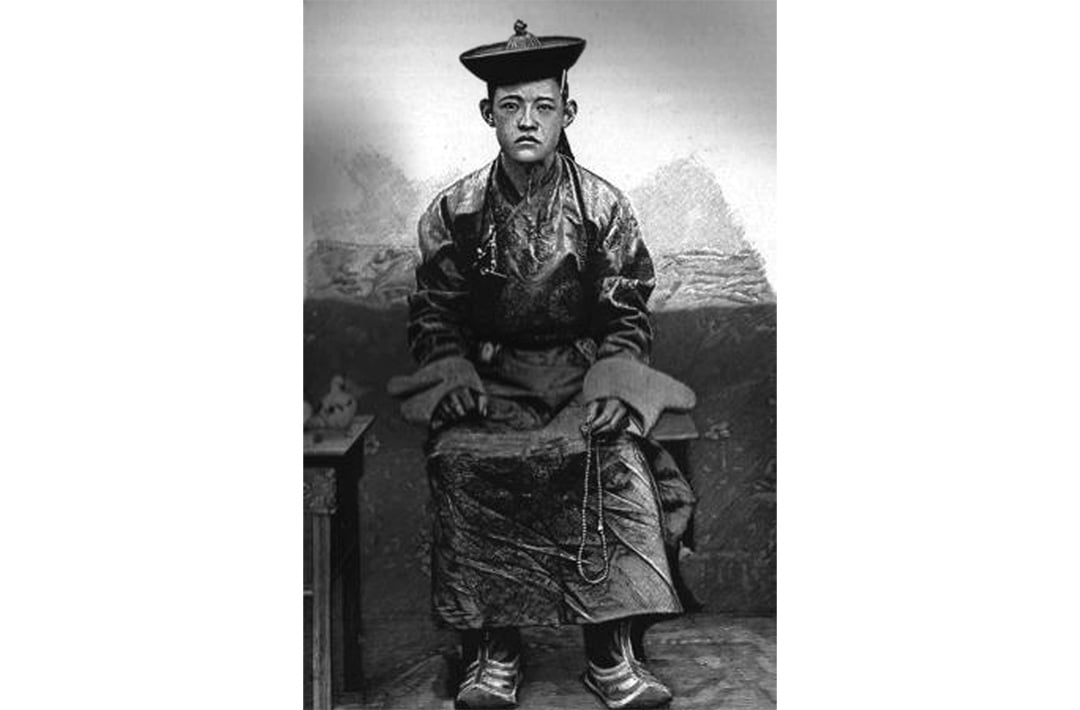 The Bogd Khan as a young boy seated, posing for a photo in the early 1900s.