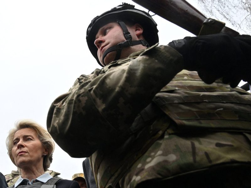 European Commission President Ursula von der Leyen and a Ukrainian soldier stand at a mass grave in Bucha, Ukraine, on April 8, 2022.