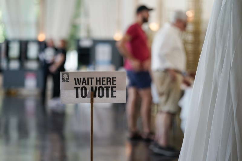 A vote sign is seen in a polling location as voters check in to cast ballots in Atlanta, Georgia on May 21.