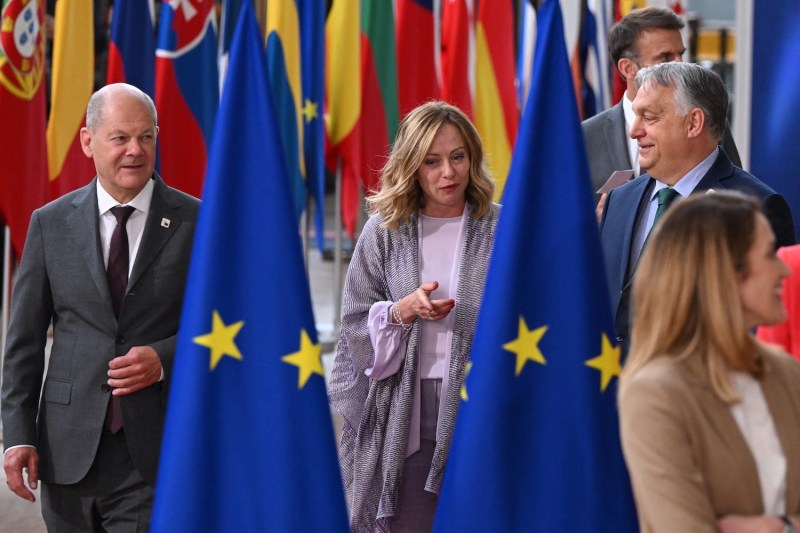 Hungary's Prime Minister Viktor Orban, Germany's Chancellor Olaf Scholz and Italy's Prime Minister Giorgia Meloni arrive for a family picture during the European Council Summit at the EU headquarters in Brussels on June 27, 2024.