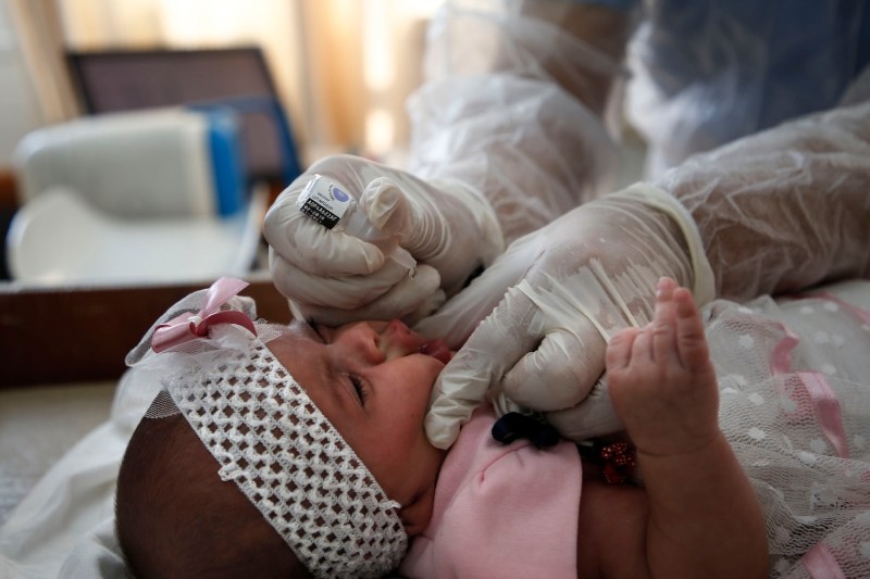 A UNRWA employee provides polio vaccine and rotavirus vaccines for children in a clinic in Bureij refugee camp in the Gaza Strip on Sept. 9, 2020.