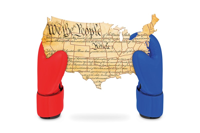 A photo illustration shows red and blue boxing gloves holding a U.S.-shaped Constitution with "We the People" on it.