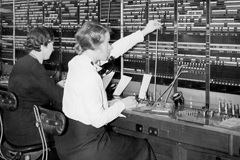 Switchboard operators manually connect calls at a telephone exchange in Paris on March 14, 1935.