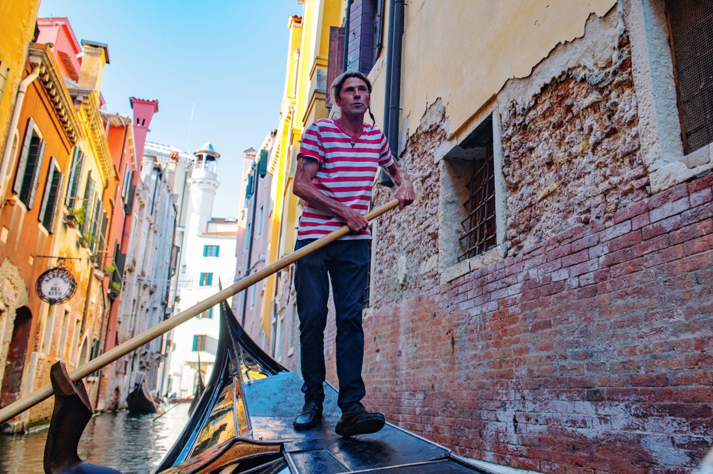 Gondolier in a small canal in Venice, Italy