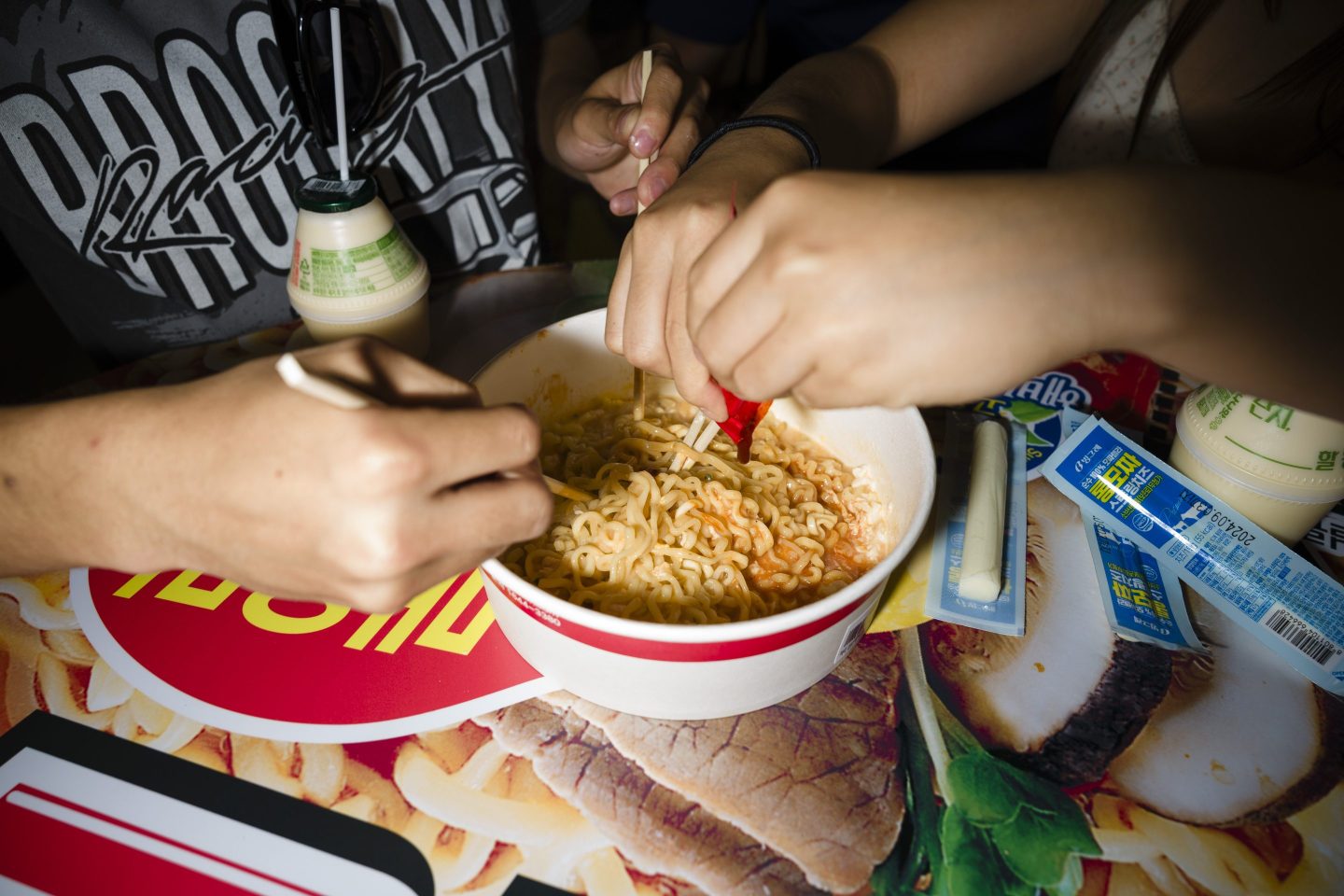 two people eating South Korea Buldak Instant Ramen noodles