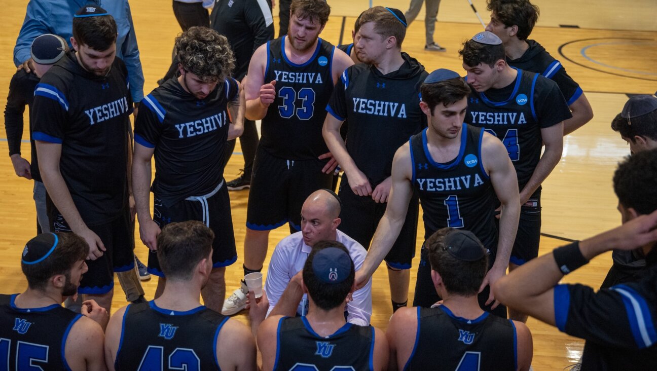 Coach Elliot Steinmetz instructs his Yeshiva University’s men’s basketball team. (YU Athletics)