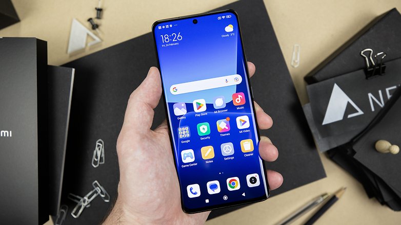 Le Xiaomi 13 Pro tenu dans une main gauche et vu de face avec son écran Amoled