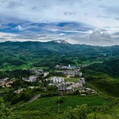 Green hills and distant city view in China