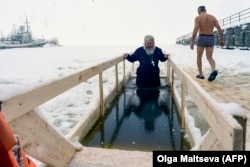 A Russian Orthodox priest takes an Epiphany dip in the icy waters of the Gulf of Finland outside St. Petersburg.