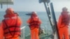 台湾海巡署公布照片显示2024年2月14日海巡人员在金门海域调查一艘中国籍快艇越界进入禁区水域。