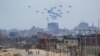 (FILE) An aircraft airdrops humanitarian aid over the northern Gaza Strip, as seen from central Gaza, April 30, 2024.