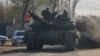 (FILE) Russian army servicemen drive a tank on a street in Donetsk, Russian-controlled Ukraine, April 6, 2024.