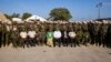 (FILE) Haitian Prime Minister Garry Conille, center, poses for a photo with members of the Kenyan police contingent at their base in Port-au-Prince, Haiti, Wednesday, June 26, 2024.