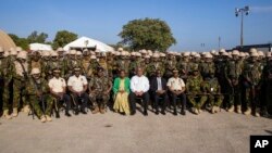 (FILE) Haitian Prime Minister Garry Conille, center, poses for a photo with members of the Kenyan police contingent at their base in Port-au-Prince, Haiti, Wednesday, June 26, 2024.