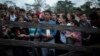 (FILE) Migrants who plan to start walking across the Darien Gap from Colombia to Panama in hopes of reaching the U.S. gather at the trailhead camp in Acandi, Colombia, May 9, 2023.