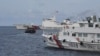 资料照片：这张拍摄于2023年8月22日的照片显示中国海警船包围驱赶菲律宾海军为了向搁浅在第二托马斯浅滩的军舰上军人运送补给而包租的一艘民船。